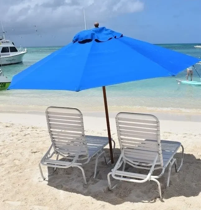 Beach umbrella and chairs standing ready on an Aruba beach